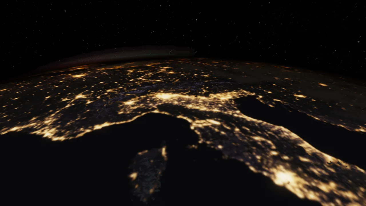 City lights across northern Italy and the Alps at night, seen from low orbit