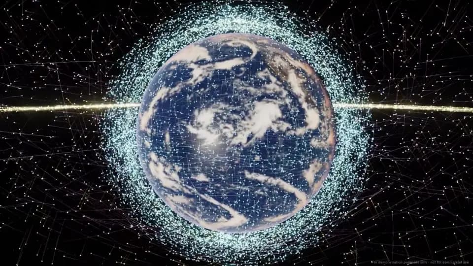 Earth from orbit wrapped in the glowing swarm of real satellites, slowly turning